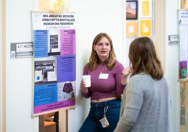 Student presenting during the Praxis Poster Session event